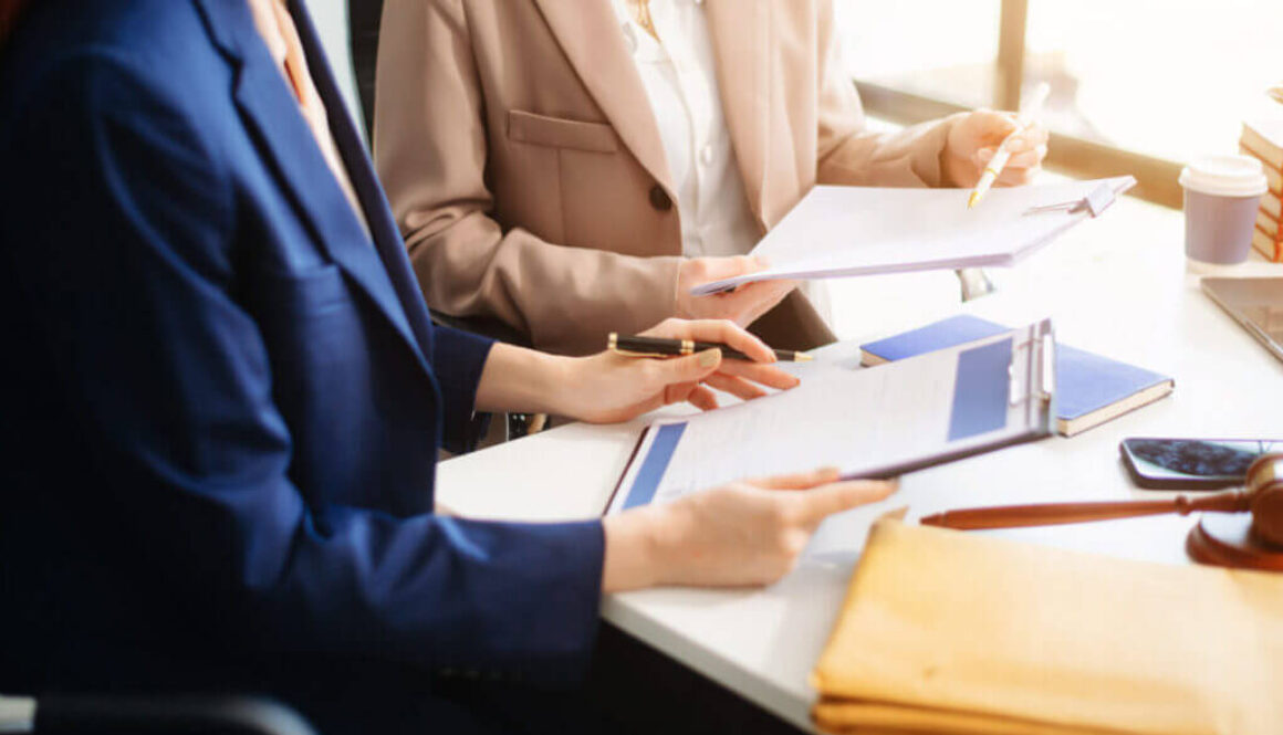 business team and lawyers discussing contract papers sitting at the table. Concepts of law, advice, legal services.