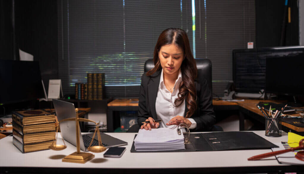 Female lawyer is working on legal documents in an office.