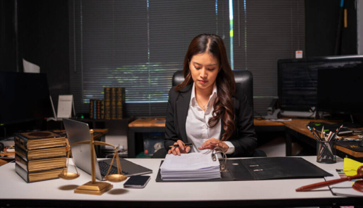 Female lawyer is working on legal documents in an office.