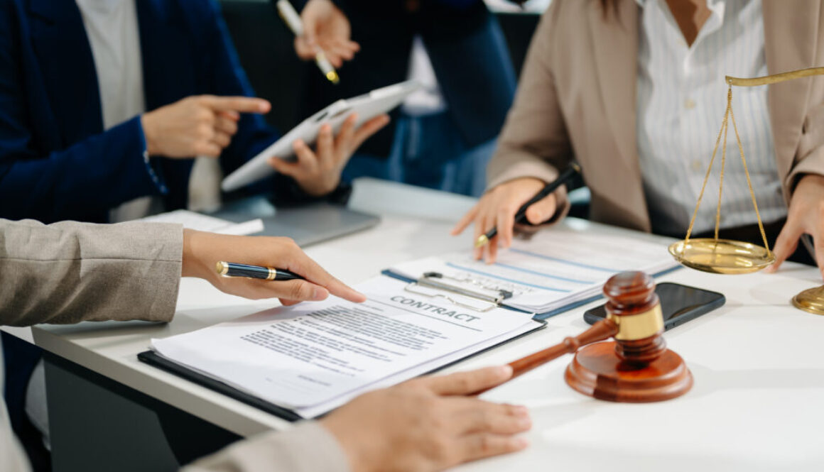 business people and lawyers discussing contract papers sitting at the table. Concepts of law, advice, legal services.