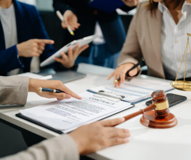 business people and lawyers discussing contract papers sitting at the table. Concepts of law, advice, legal services.